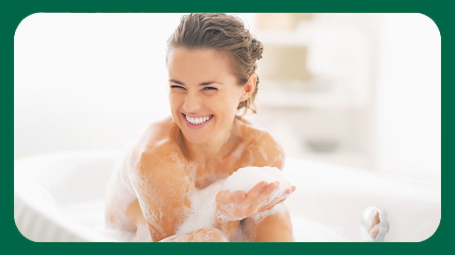 Lady taking a bath in a bathtub using body wash for dry skin Lady taking a bath in a bathtub using body wash for dry skin