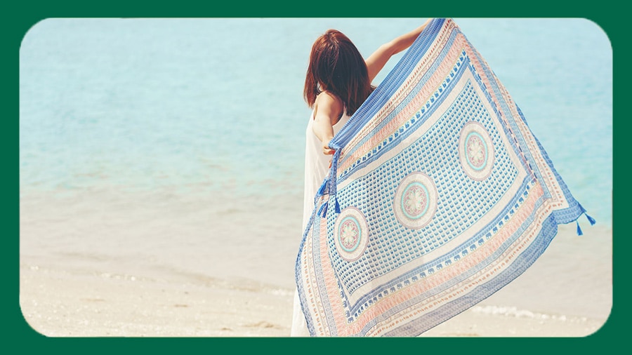 Lady enjoying the aroma of a top fragrance body wash by the sea shore Lady enjoying the aroma of a top fragrance body wash by the sea shore